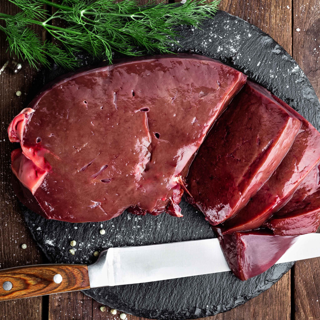 Assorted cuts of raw beef, including ribeye and tenderloin, displayed on a wooden cutting board with fresh rosemary, a mortar and pestle, and a bowl of sea salt, highlighting gourmet cooking ingredients.